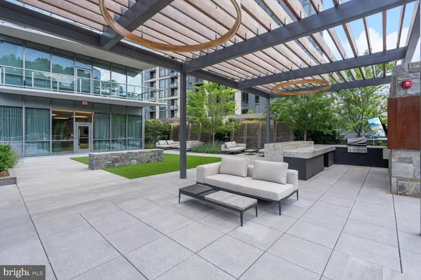 a living room with patio furniture and a garden