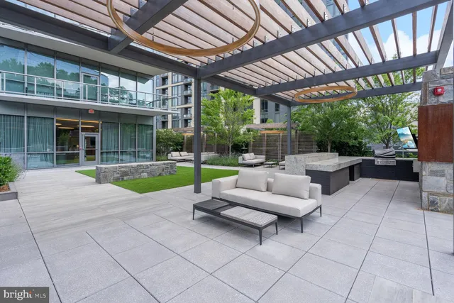 a living room with patio furniture and a garden
