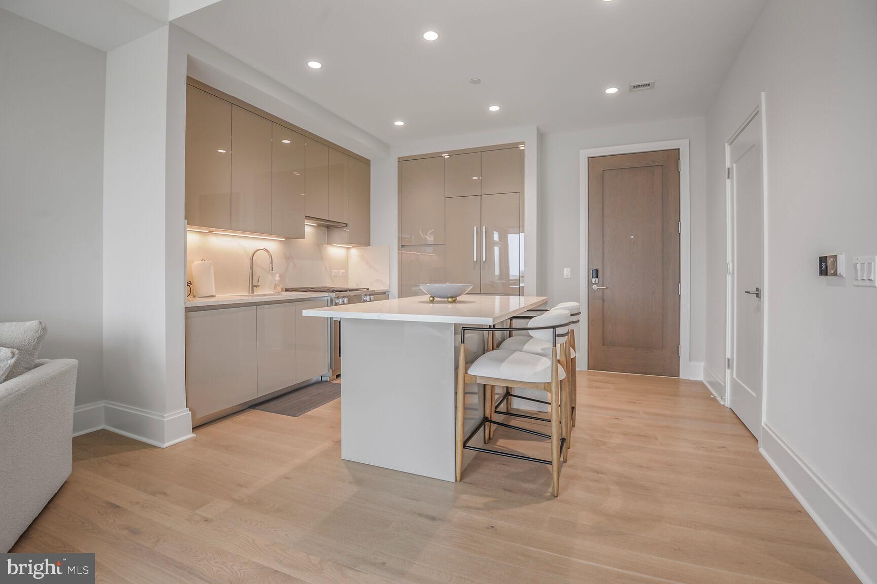 7887 Jones Branch Drive, Unit 803 McLean, VA 22102 - Photo 4 of 35 a kitchen with a sink cabinets and wooden floor