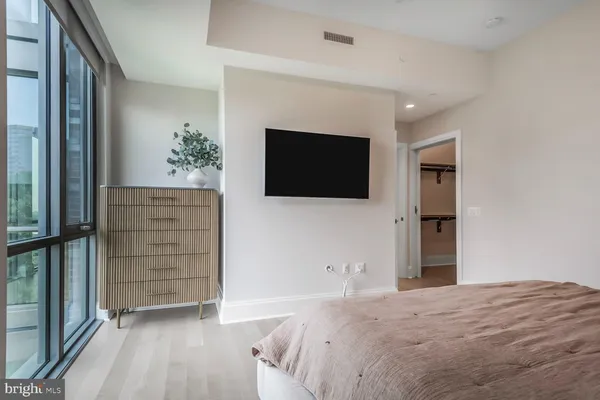 a bedroom with a bed and a window