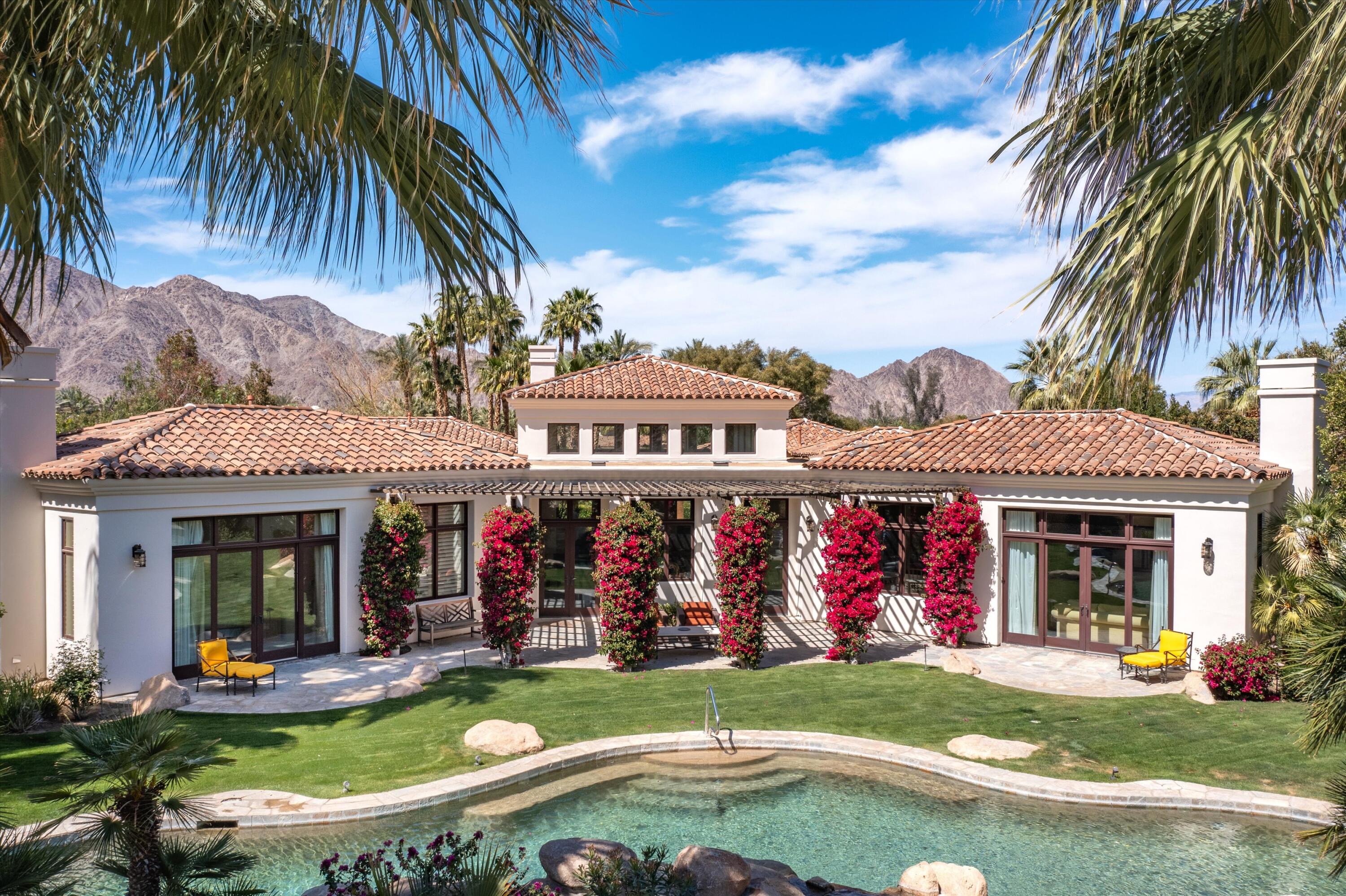 78411 Talking Rock Turn La Quinta, CA 92253 - Photo 27 of 70 a view of a swimming pool with lawn chairs under an umbrella