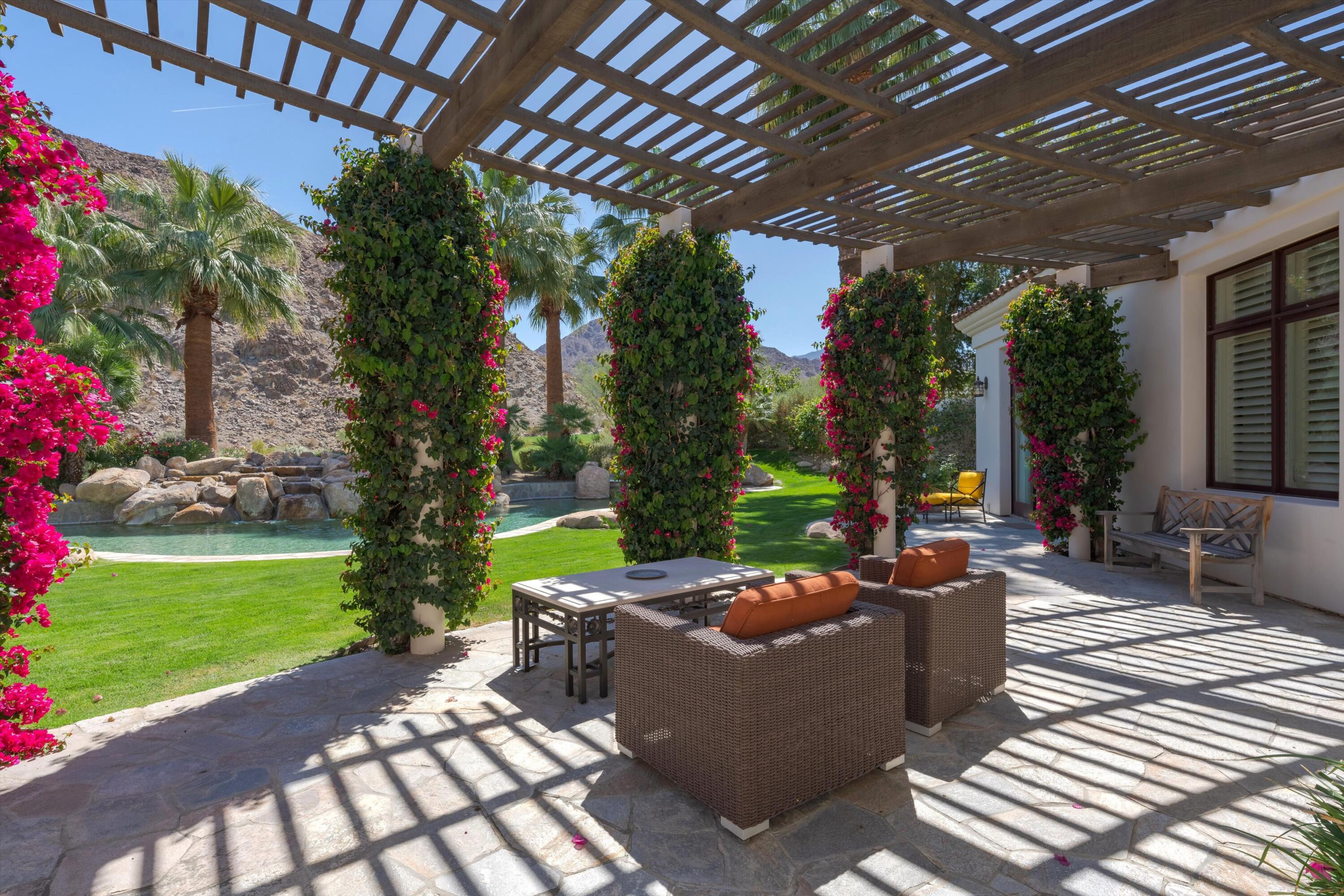 78411 Talking Rock Turn La Quinta, CA 92253 - Photo 30 of 70 a view of a patio with couches potted plants and a big yard