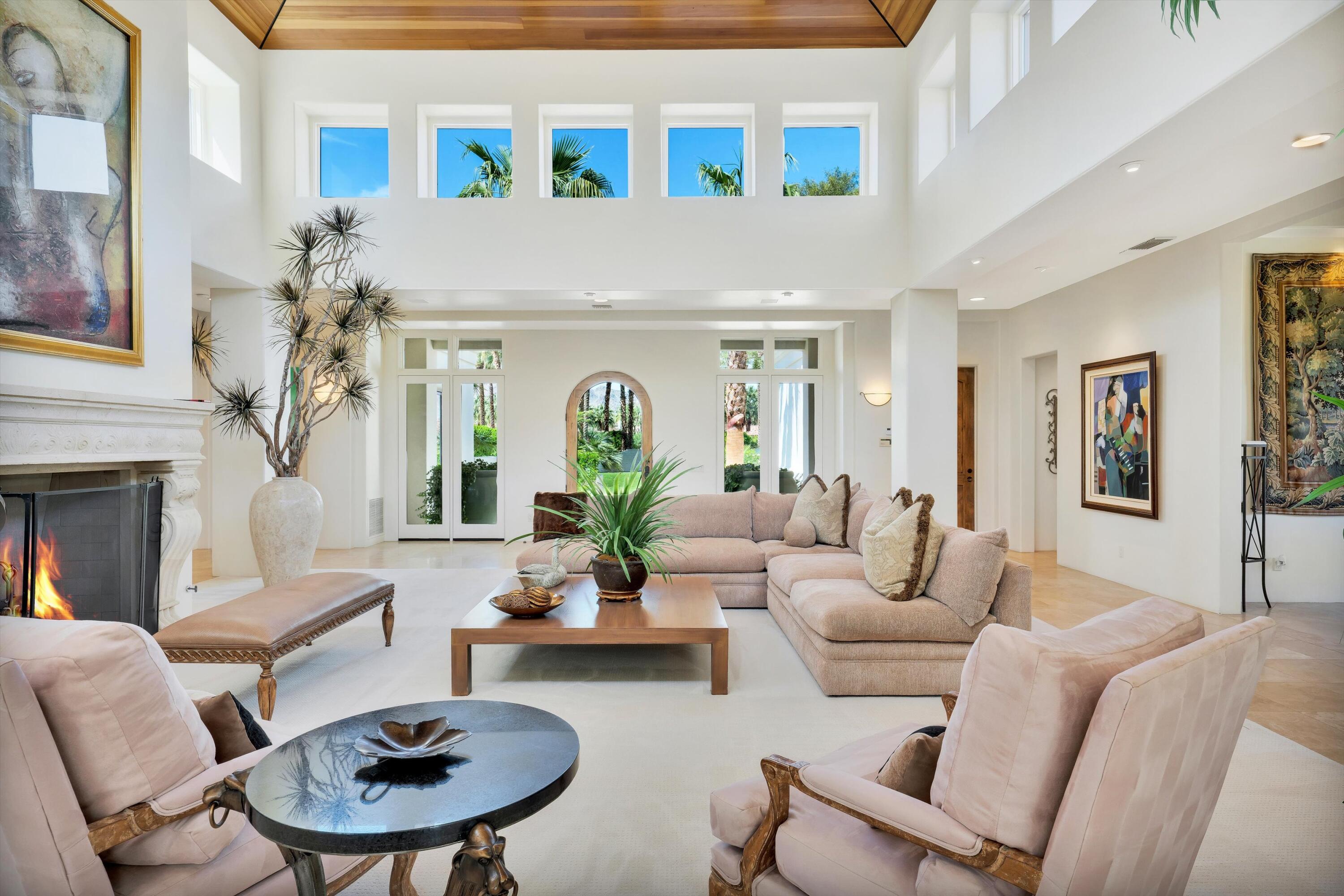 78411 Talking Rock Turn La Quinta, CA 92253 - Photo 38 of 70 a living room with furniture a fireplace and a chandelier