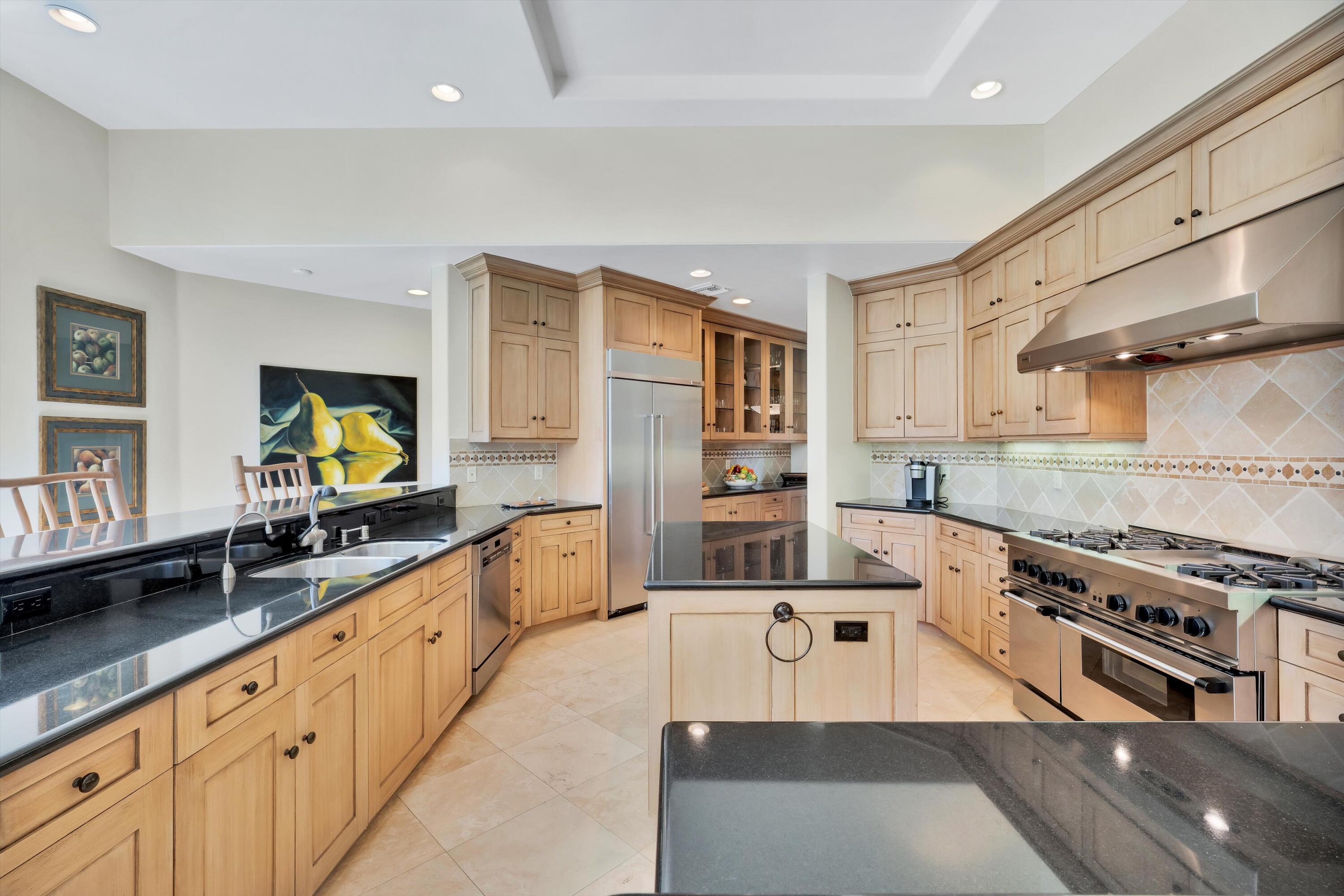 78411 Talking Rock Turn La Quinta, CA 92253 - Photo 44 of 70 a large kitchen with stainless steel appliances a stove a sink and a refrigerator