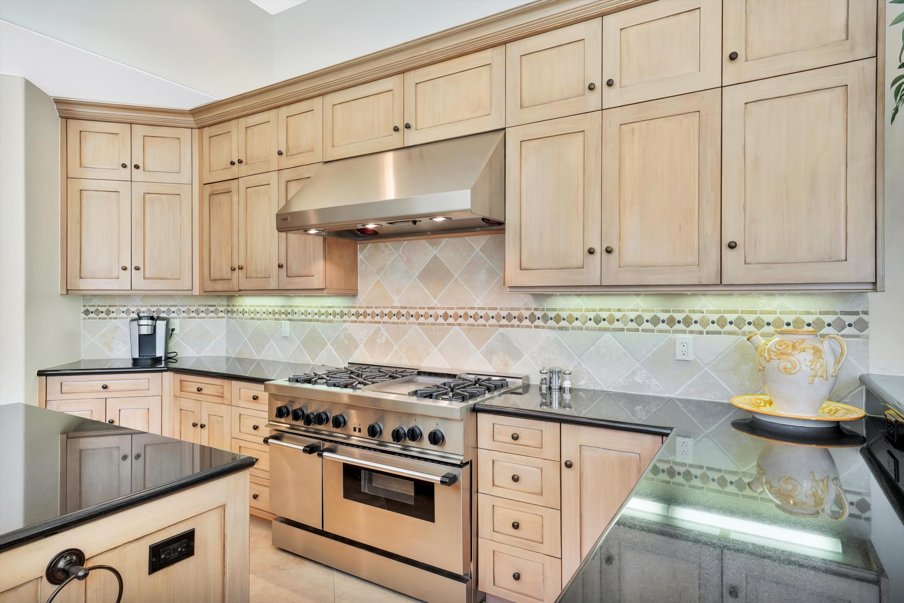 78411 Talking Rock Turn La Quinta, CA 92253 - Photo 45 of 70 a kitchen with stainless steel appliances granite countertop a sink and a stove