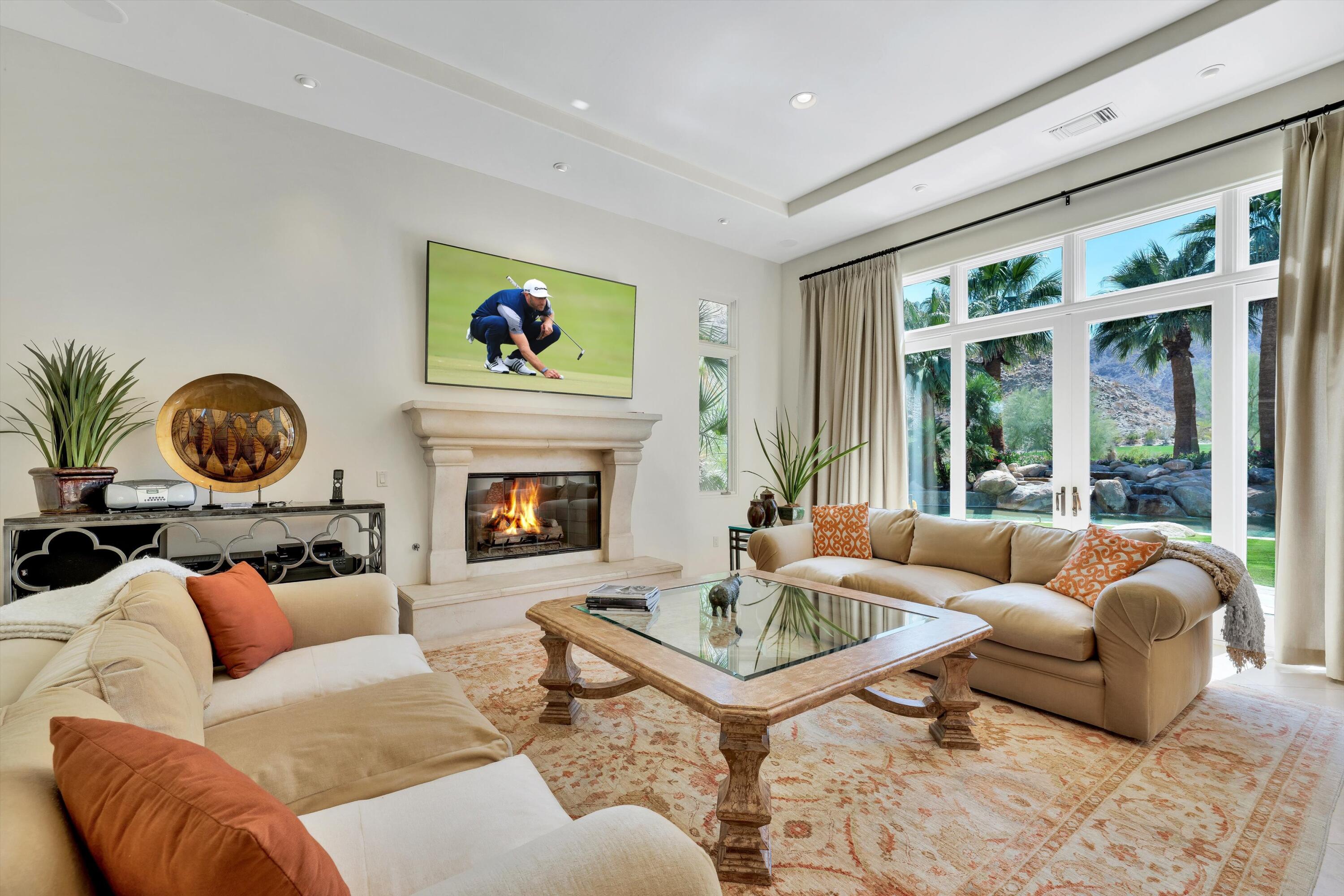 78411 Talking Rock Turn La Quinta, CA 92253 - Photo 49 of 70 a living room with furniture a fireplace and a large window