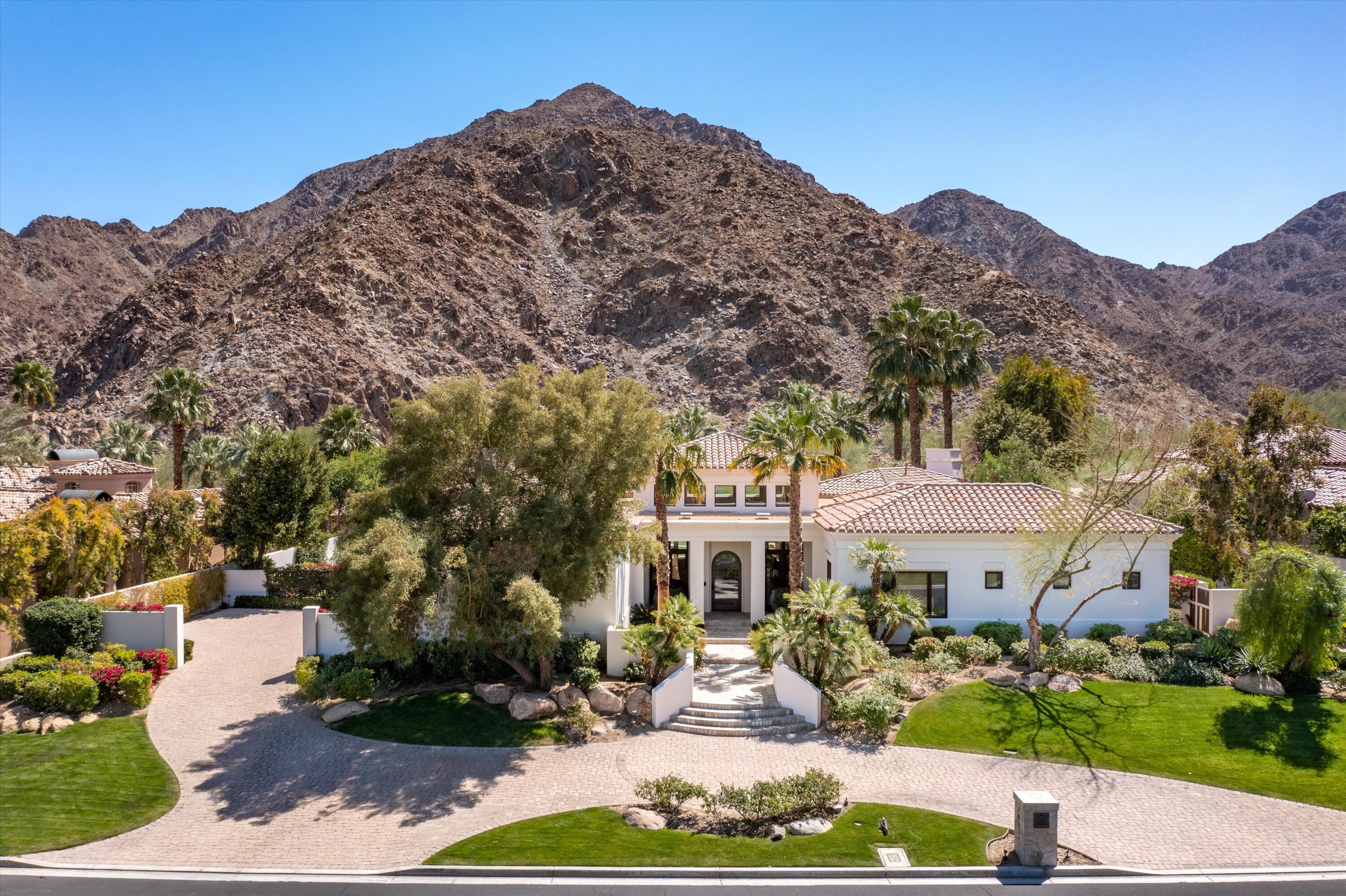 78411 Talking Rock Turn La Quinta, CA 92253 - Photo 5 of 70 a front view of a house with a yard and mountain view in back