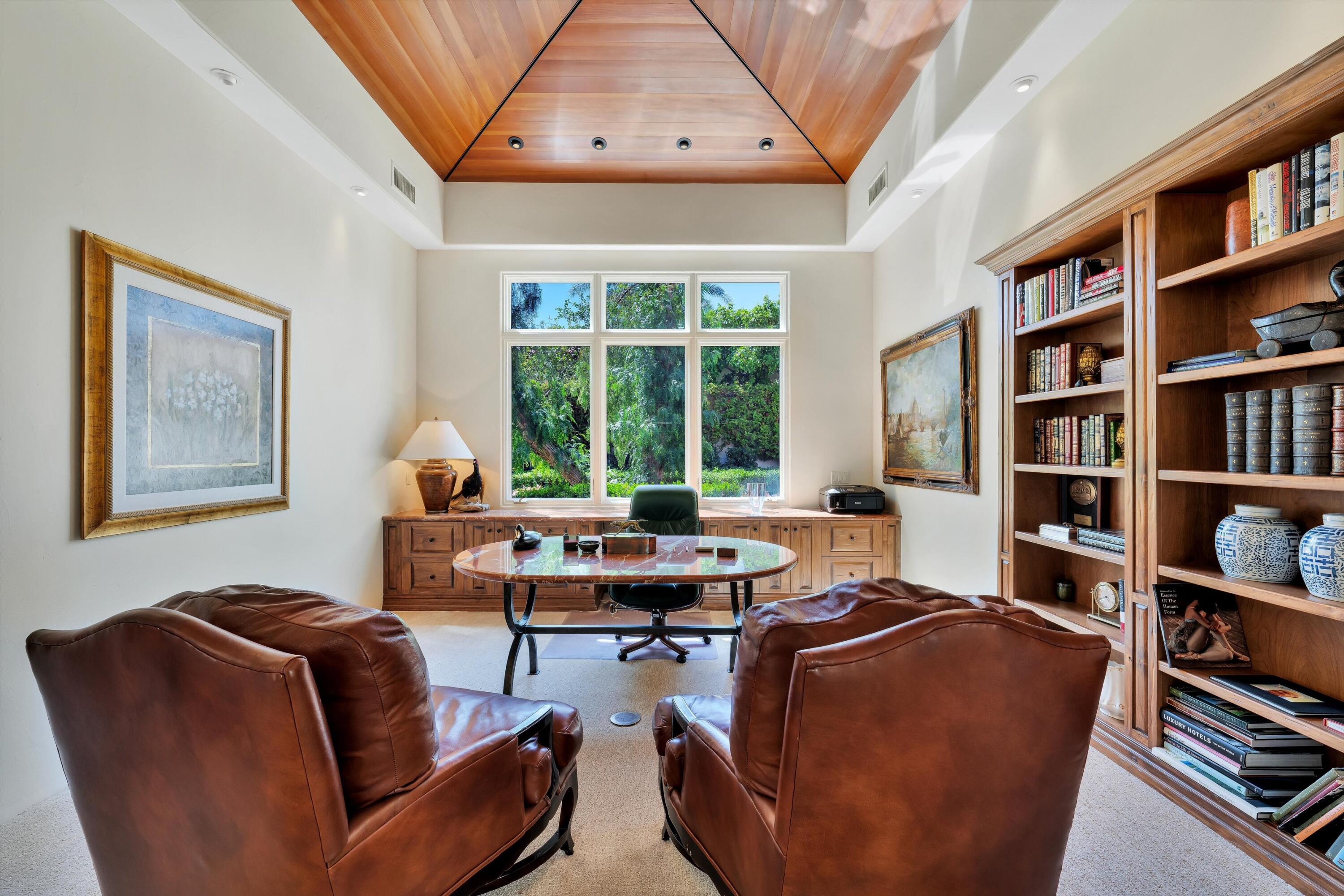78411 Talking Rock Turn La Quinta, CA 92253 - Photo 52 of 70 a living room with furniture and a book shelf