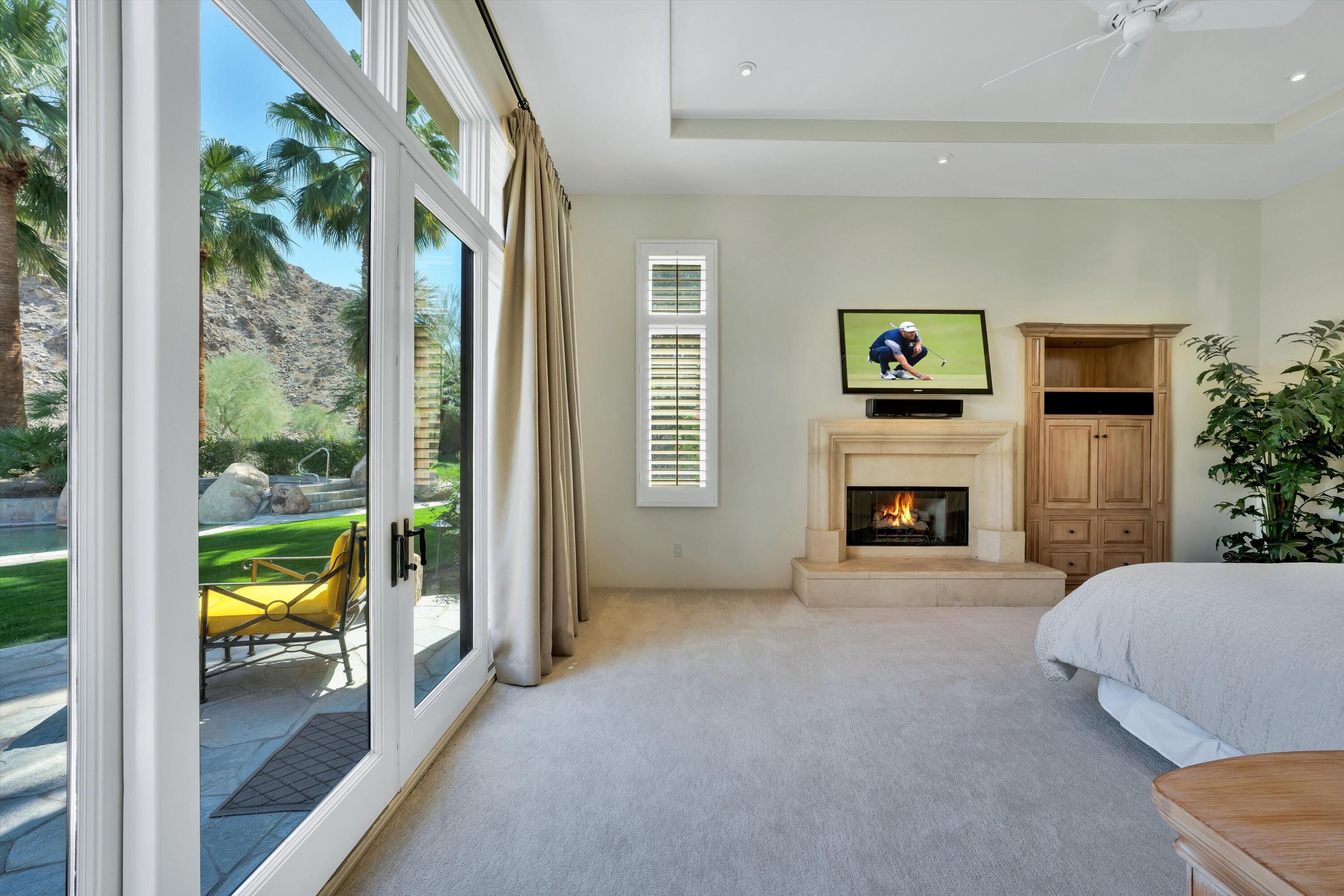 78411 Talking Rock Turn La Quinta, CA 92253 - Photo 54 of 70 a bedroom with furniture and a fireplace