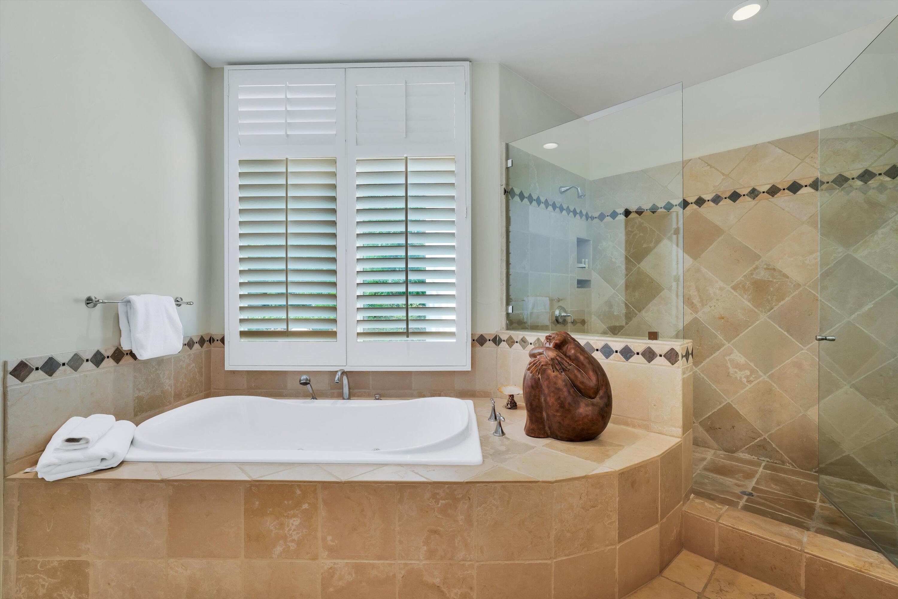 78411 Talking Rock Turn La Quinta, CA 92253 - Photo 58 of 70 a bathroom with a bathtub and shower