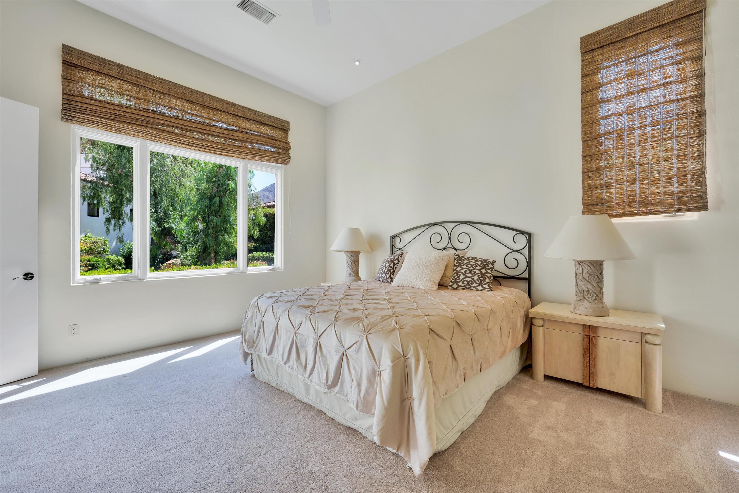 78411 Talking Rock Turn La Quinta, CA 92253 - Photo 62 of 70 a bedroom with a bed next to a window