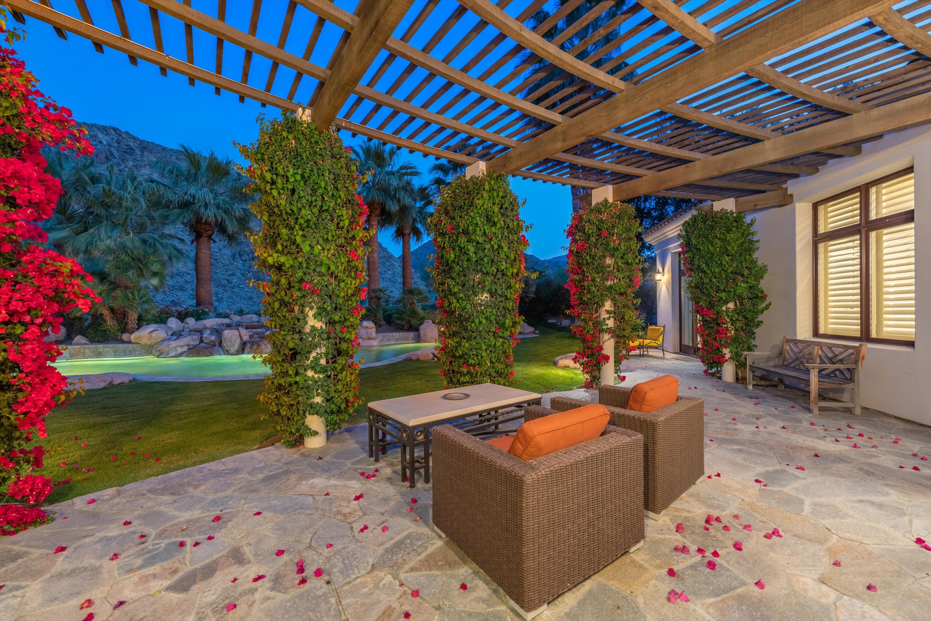 78411 Talking Rock Turn La Quinta, CA 92253 - Photo 64 of 70 a outdoor space with the couches and dining table with garden view