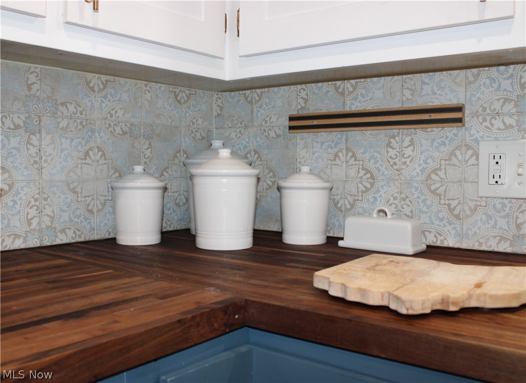5547 River Styx Road Medina, OH 44256 - Photo 13 of 45 Butcher block countertops paired with a decorative tile backsplash featuring an intricate pattern