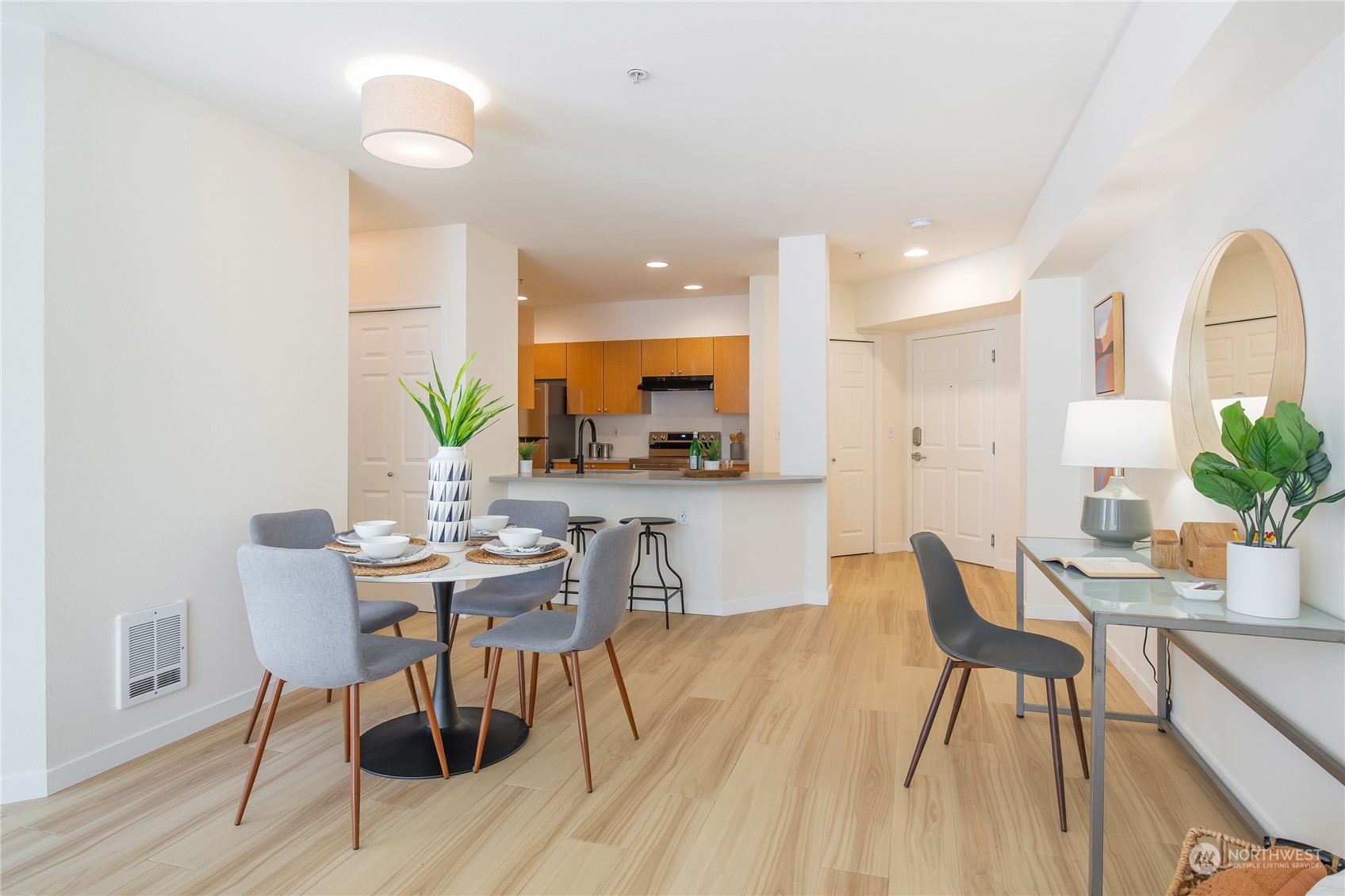 18 Dravus Street, Unit 210 Seattle, WA 98109 - Photo 21 of 38 a view of a dining room with furniture and wooden floor