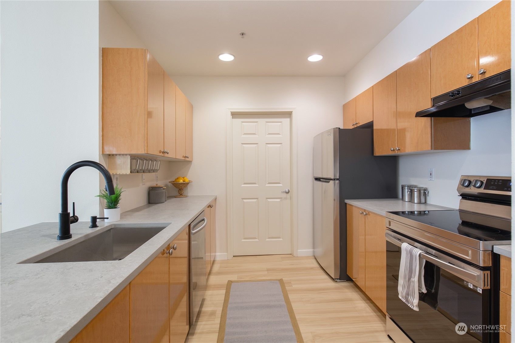 18 Dravus Street, Unit 210 Seattle, WA 98109 - Photo 4 of 38 a kitchen with stainless steel appliances granite countertop a sink stove and refrigerator