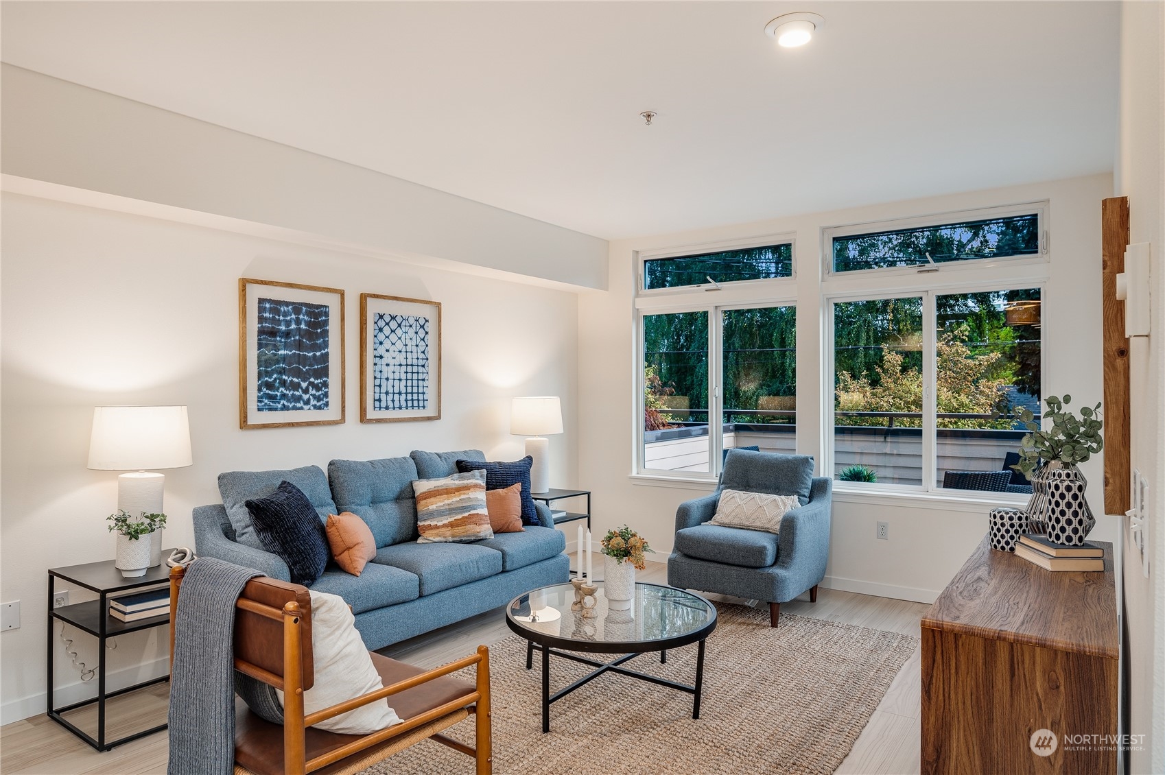 18 Dravus Street, Unit 210 Seattle, WA 98109 - Photo 6 of 38 a living room with furniture and a large window