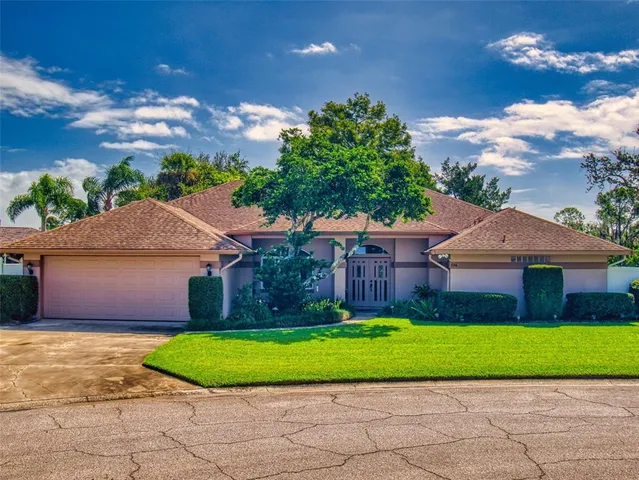 a front view of a house with a garden and yard