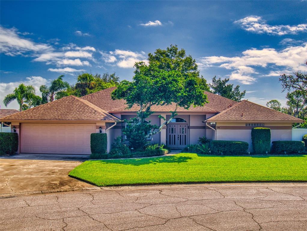a front view of a house with a garden and yard