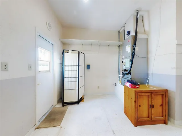a view of empty room with a fireplace and fan