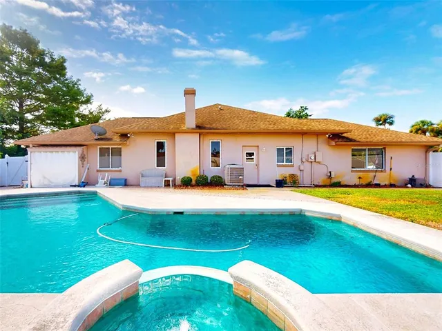 an empty room with a fireplace and windows