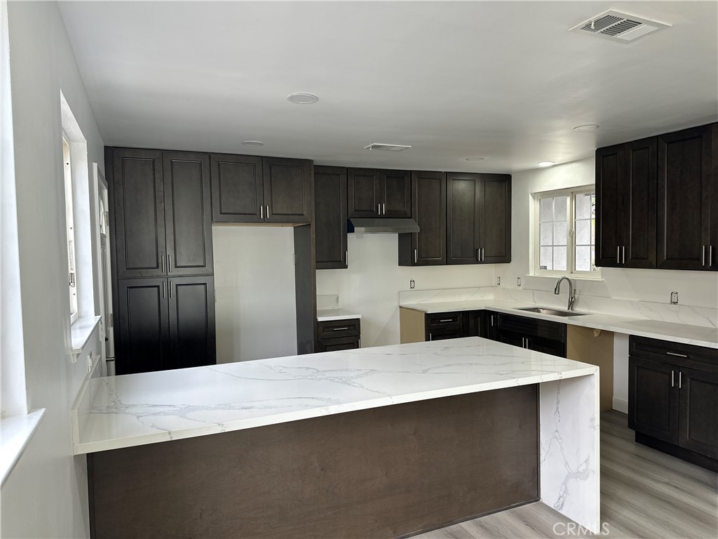 1021 Gaillard Street Azusa, CA 91702 - Photo 19 of 24 a kitchen with refrigerator and cabinets