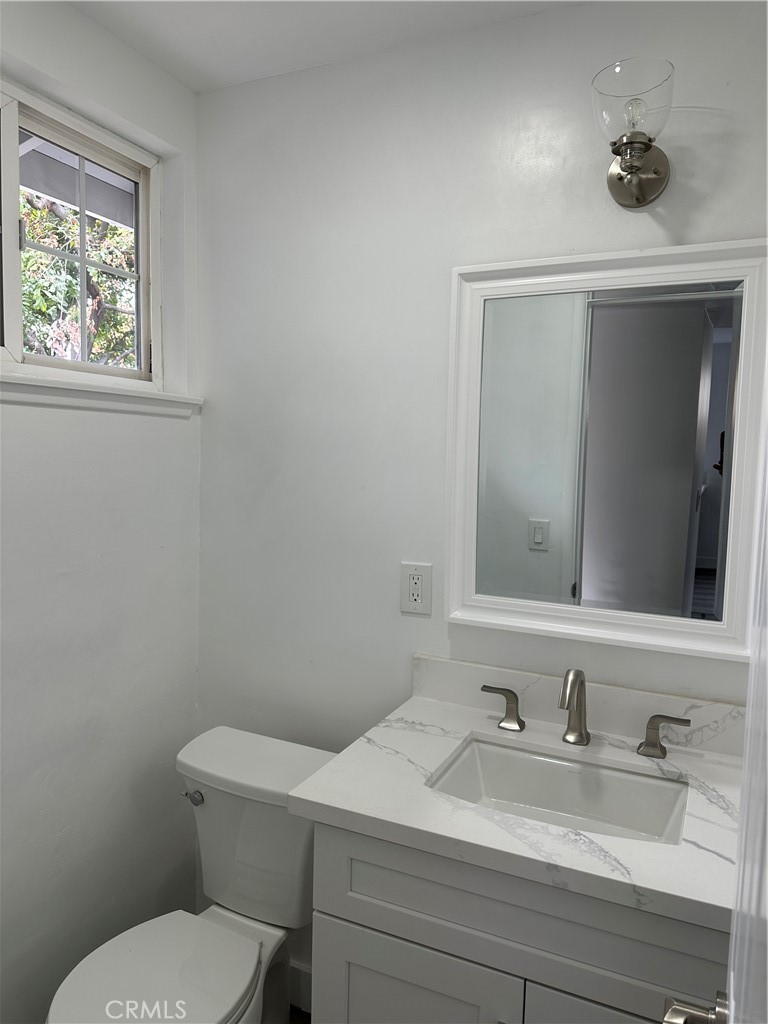 1021 Gaillard Street Azusa, CA 91702 - Photo 5 of 24 a bathroom with a toilet a sink and mirror