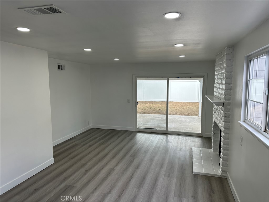1021 Gaillard Street Azusa, CA 91702 - Photo 6 of 24 an empty room with wooden floor and windows