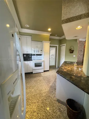 a kitchen with a stove a refrigerator and a sink