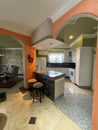 a kitchen with a refrigerator and a sink