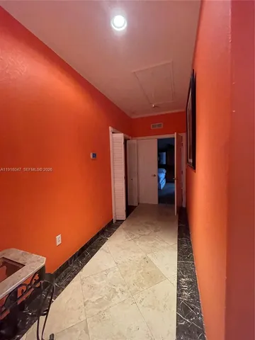 a room with furniture pool table and window