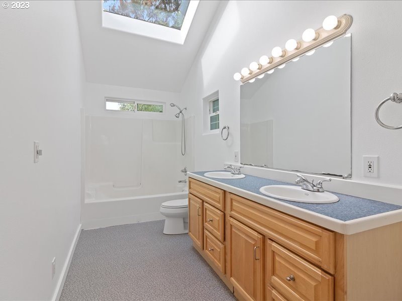 4155 Mapleton Drive West Linn, OR 97068 - Photo 21 of 38 a bathroom with a sink a toilet a mirror and bathtub
