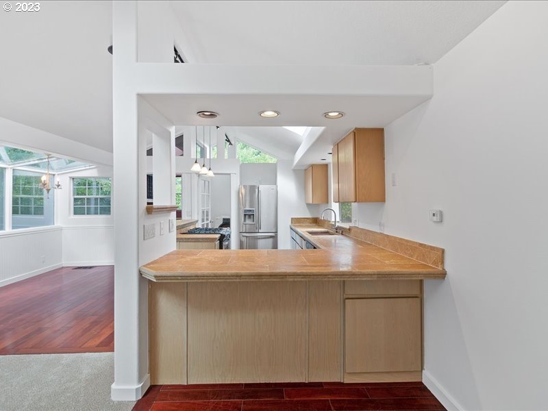 4155 Mapleton Drive West Linn, OR 97068 - Photo 8 of 38 a room with kitchen island a sink and wooden floor