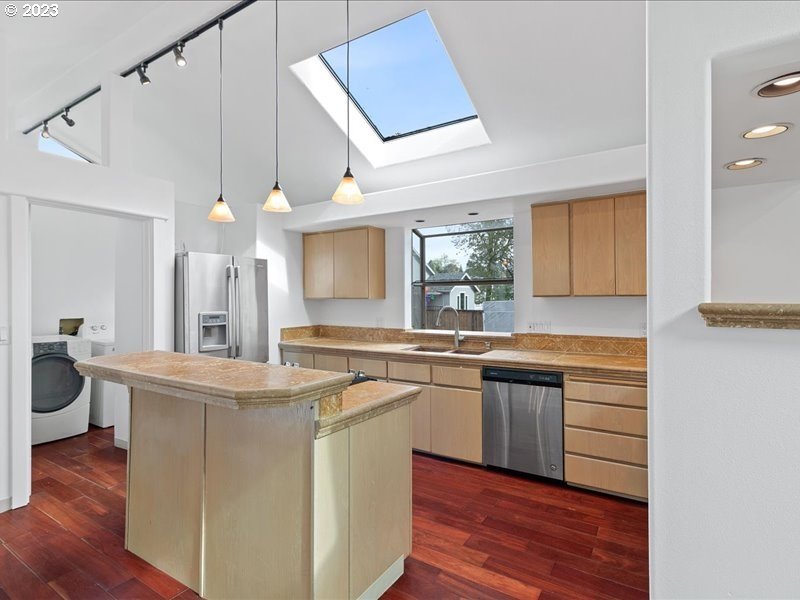 4155 Mapleton Drive West Linn, OR 97068 - Photo 9 of 38 a kitchen with stainless steel appliances granite countertop a sink stove and wooden floor