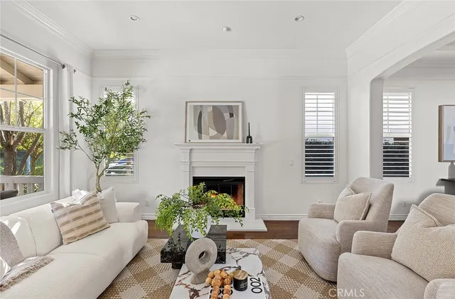 a living room with furniture a chandelier and a dining table