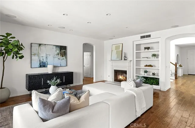 a kitchen with stainless steel appliances granite countertop a refrigerator a stove a sink a dining table and chairs