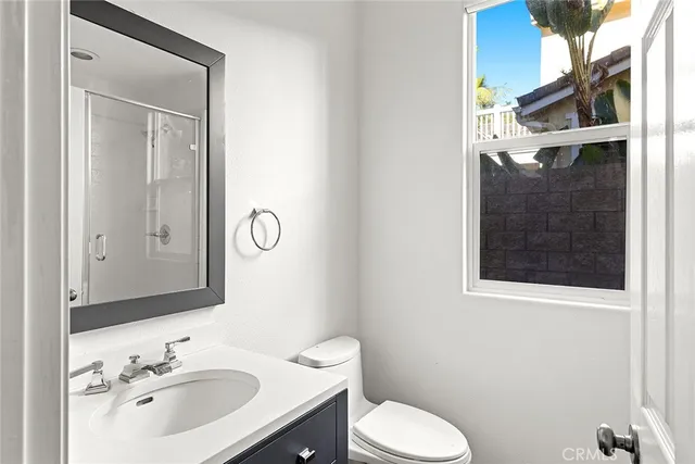 a spacious bedroom with a large bed and potted plant