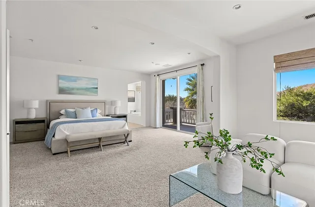 a bedroom with a bed and glass window