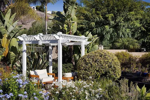 a view of a patio with couches table and chairs and potted plants