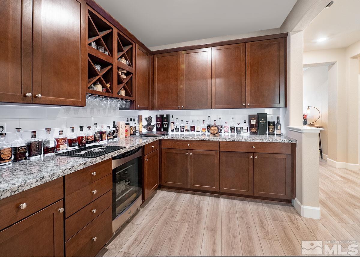 10310 Palladium Mine Drive Reno, NV 89521 - Photo 11 of 35 a kitchen with stainless steel appliances granite countertop wooden cabinets a sink and dishwasher