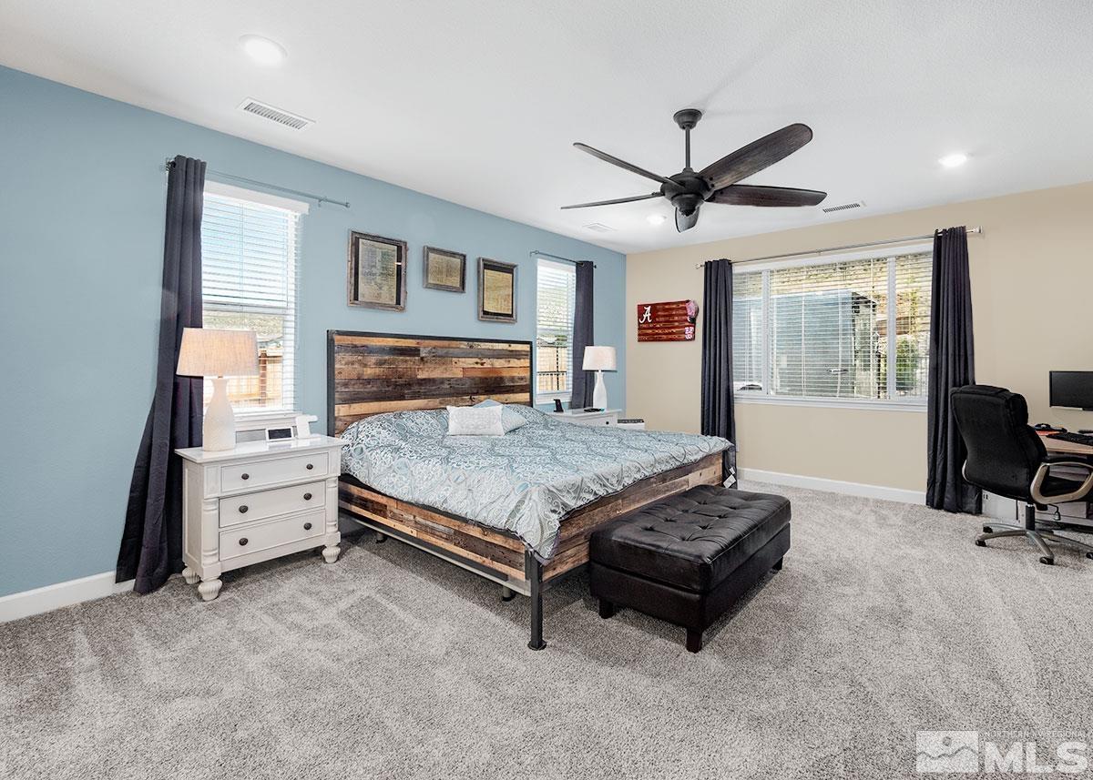 10310 Palladium Mine Drive Reno, NV 89521 - Photo 13 of 35 a bedroom with a bed and a chandelier