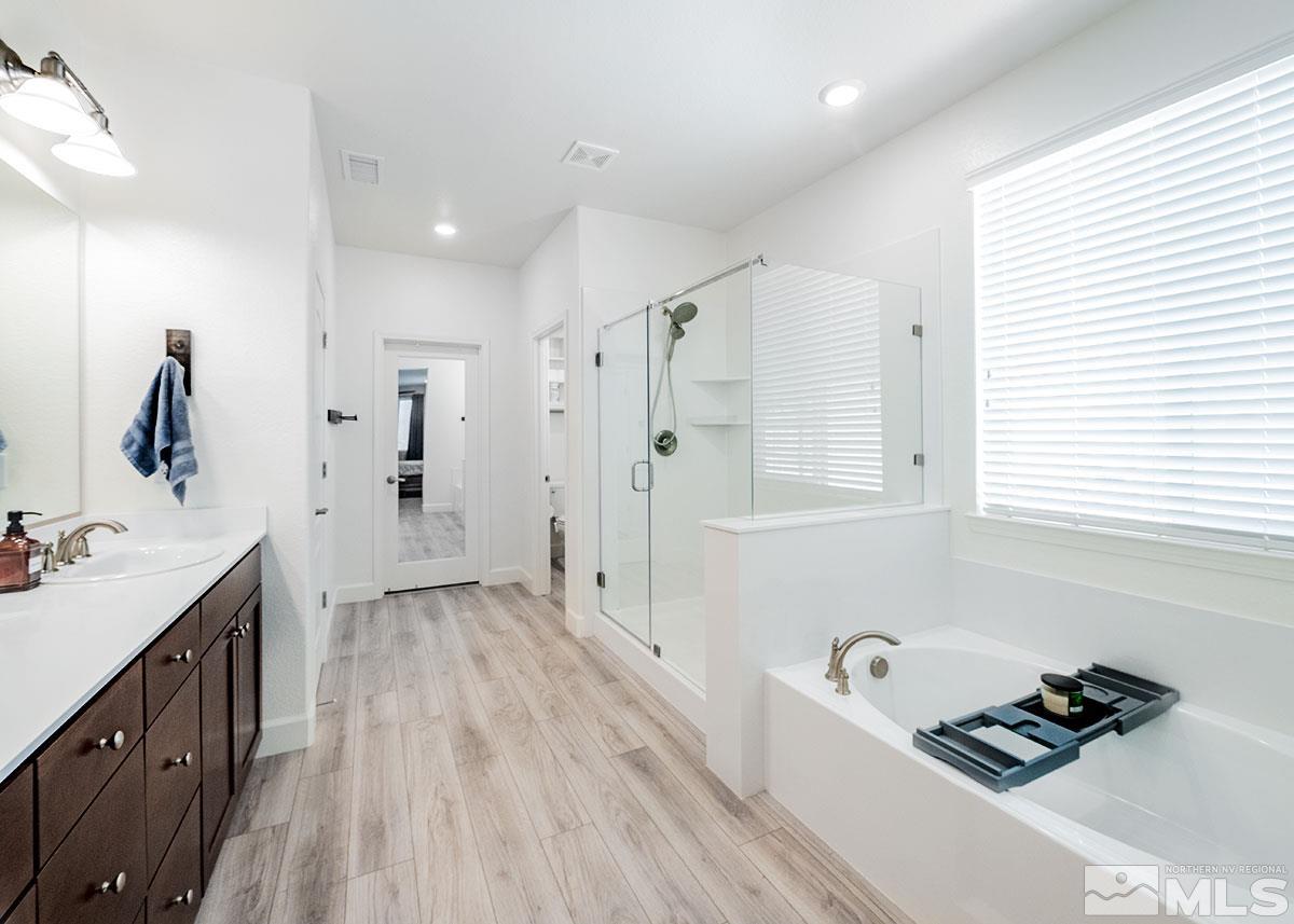10310 Palladium Mine Drive Reno, NV 89521 - Photo 14 of 35 a spacious bathroom with a bathtub sink and mirror