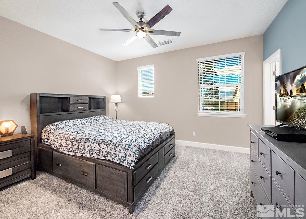 10310 Palladium Mine Drive Reno, NV 89521 - Photo 17 of 35 a bedroom with a bed and a flat screen tv