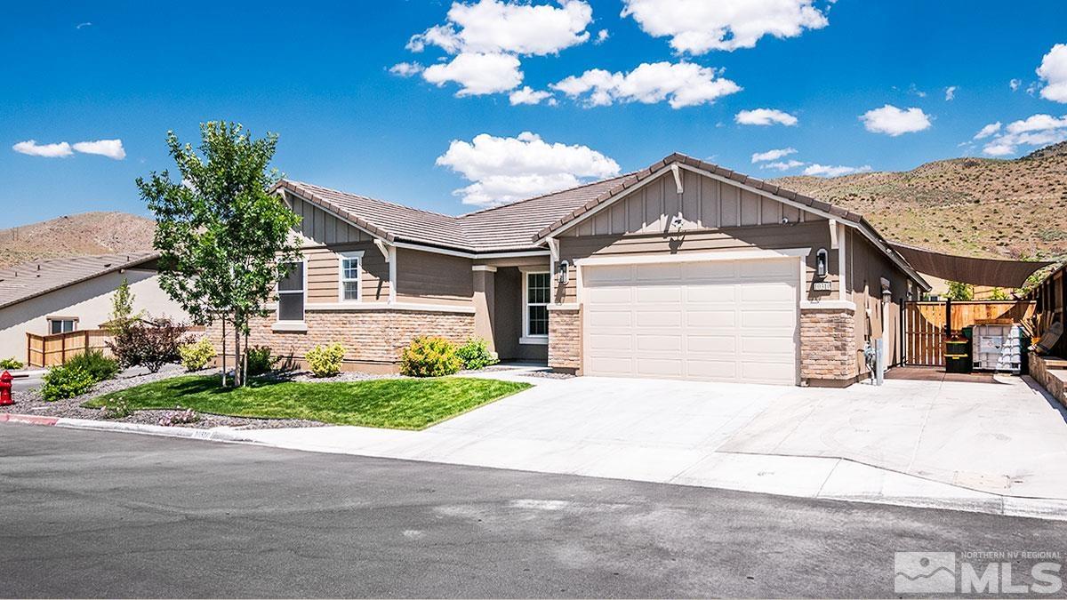 10310 Palladium Mine Drive Reno, NV 89521 - Photo 2 of 35 a front view of a house with a yard and garage