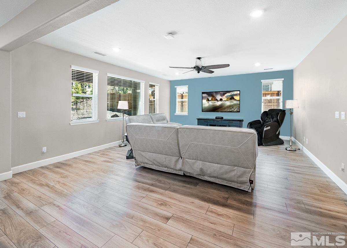 10310 Palladium Mine Drive Reno, NV 89521 - Photo 8 of 35 a living room with furniture and a flat screen tv