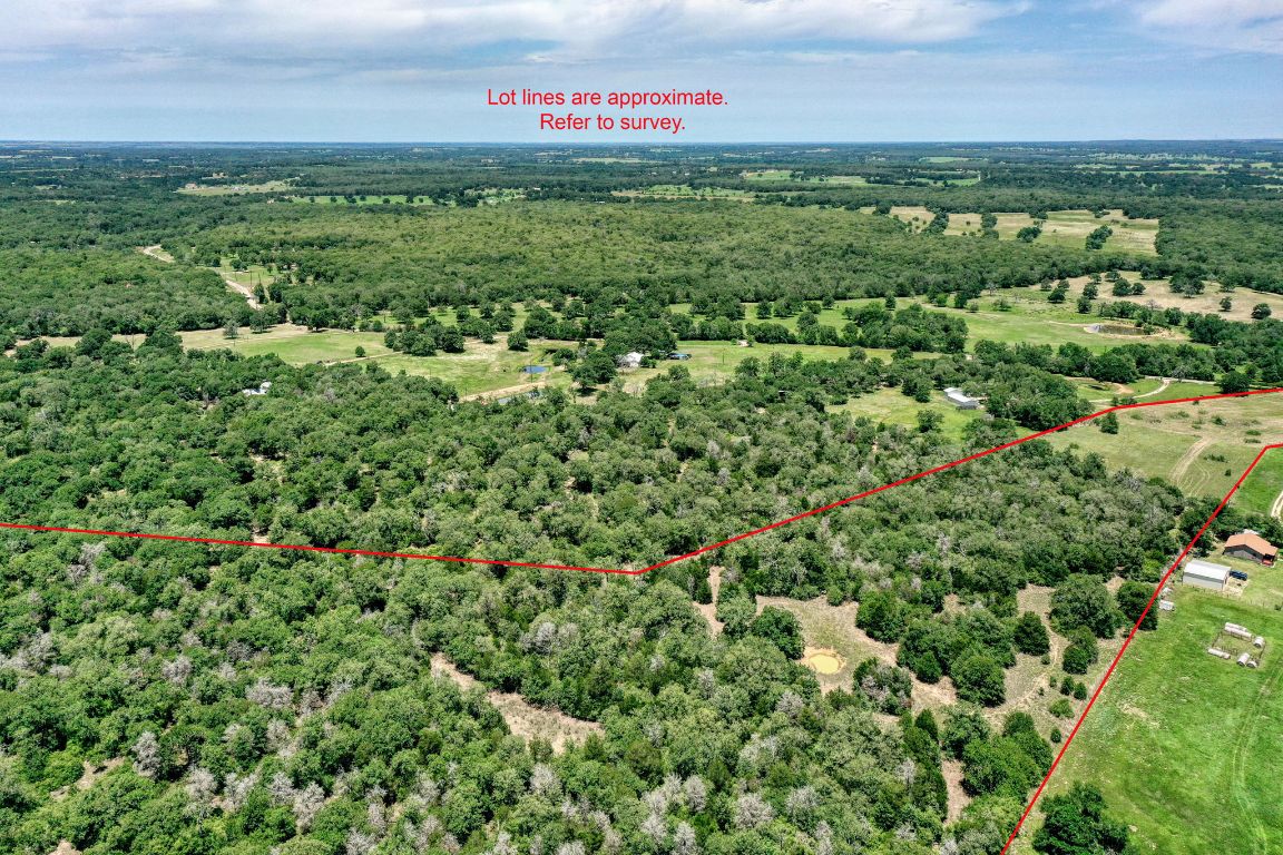 an aerial view of a houses with a yard