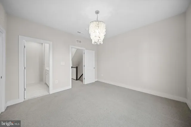 a view of a chandelier in big room and chandelier