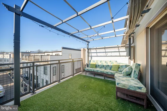 a view of a porch with furniture and garden