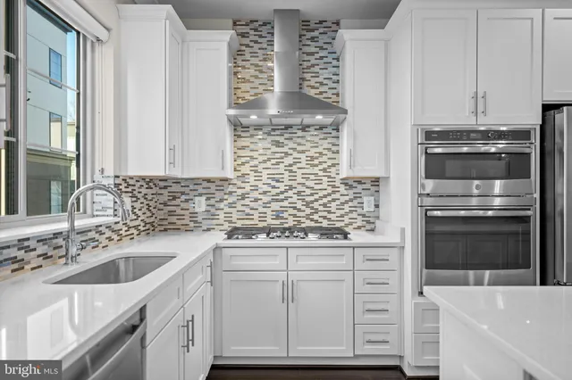 a kitchen with cabinets and appliances