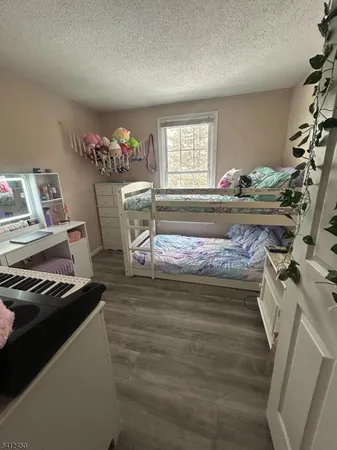 a living room with furniture and a mirror