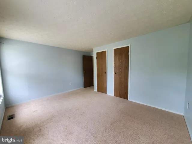 a view of an empty room and closet